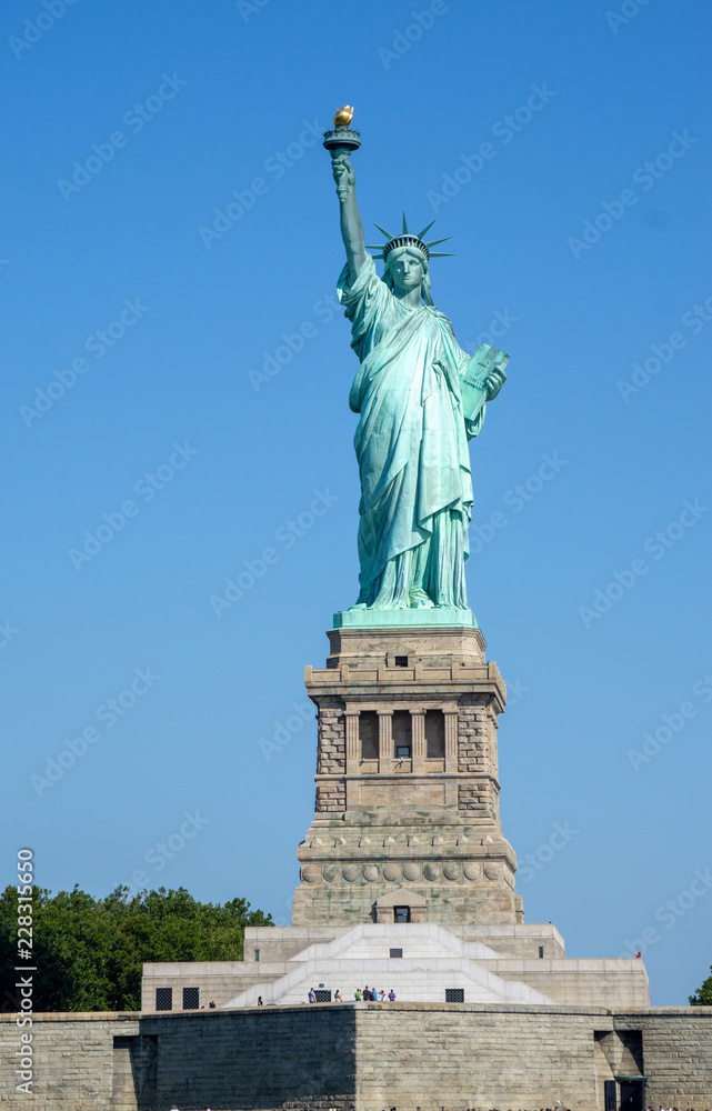 The Statue of Liberty in New York City isolated on on a blue sky background