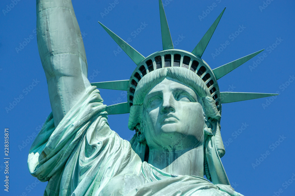 Fototapeta premium Statue of Liberty front close up on a blue sky background New York City