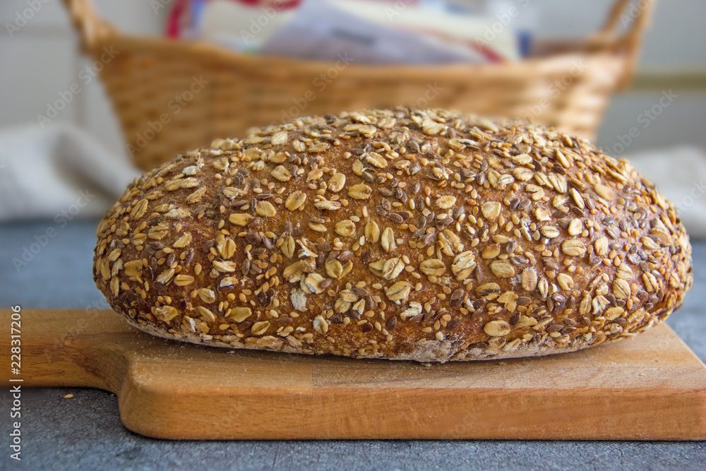 Bread on pergamet paper. Multi-grain healthy bread.Beautiful homemade bread sprinkled with grains on top. Bread on pergamet paper. Multi-grain healthy bread.Beautiful homemade bread sprinkled with grains on top.