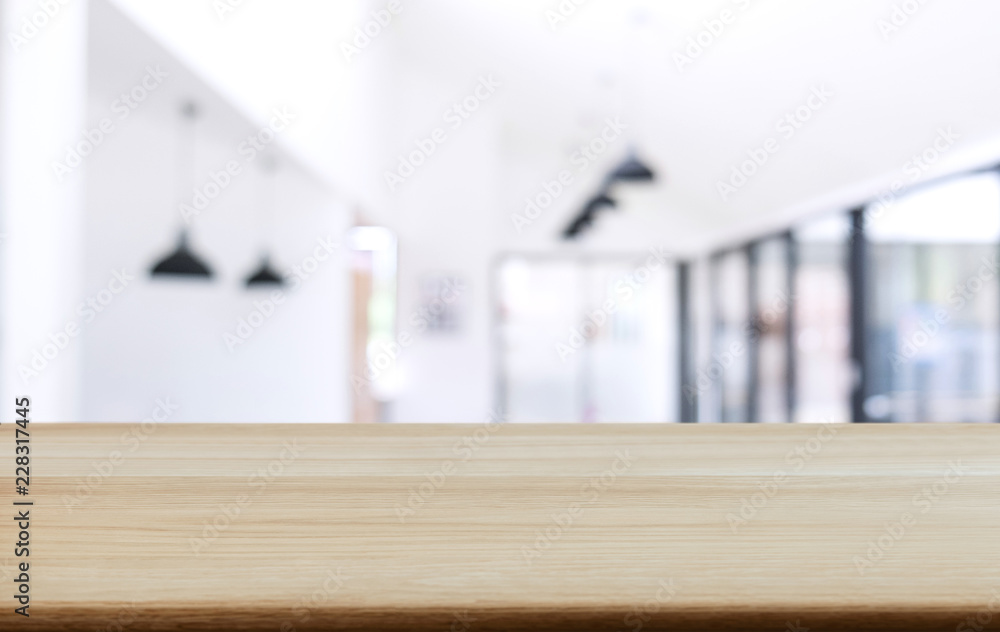 Empty wooden table and blurred background of abstract in front of coffee shop or restaurant for display of product or for montage
