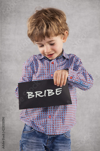 little businessman with a envelope, concept of bribing  photo