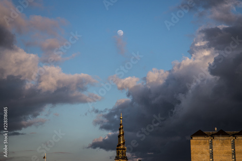 Vor Frelsers Kirke, Church of Our Saviour in Copenhagen, Denmark at sunset with dark cloudes and moon photo