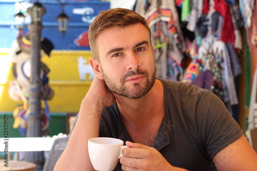 Brunette man holding a mug 