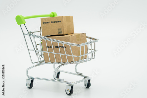 Online shopping with a shopping cart and shopping bags delivery service using as background shopping concept and delivery service concept with copy space for your text or design.