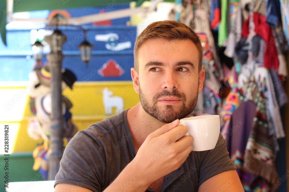 Fototapeta premium Attractive man enjoying a cup of coffee
