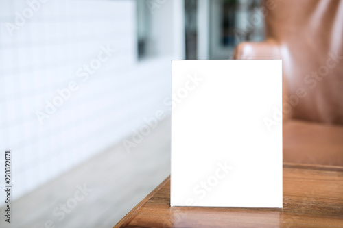 Mock up blank menu frame on table in coffee shop stand for your text of display your product