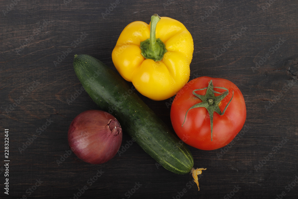 cucumber, tomato, red onion and yellow pepper on wooden background cucumber, tomato, red onion and yellow pepper on wooden background