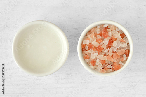 Homemade face scrub made out of Himalayan pink salt and coconut oil on wooden background