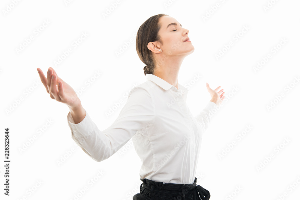 Side view of young business woman standing with open arms Side view of young business woman standing with open arms