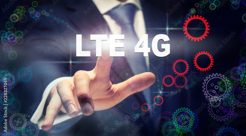 A businessman pressing a LTE 4G business concept on a graphical display of cogs A businessman pressing a LTE 4G business concept on a graphical display of cogs