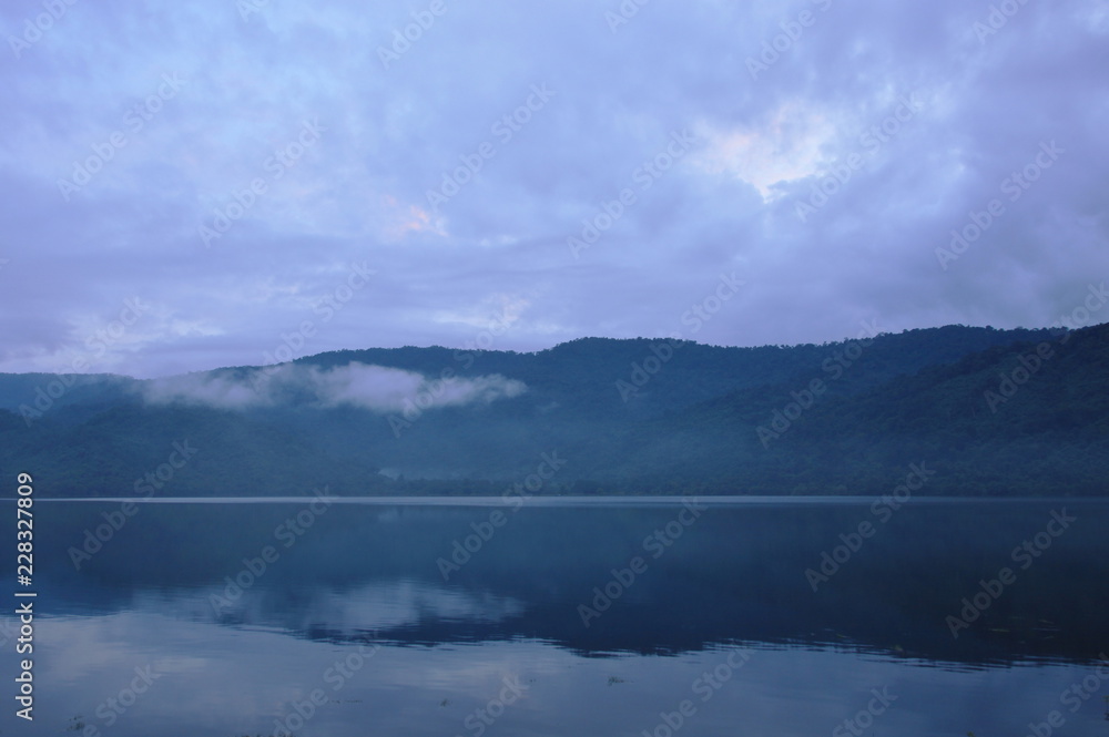 landscape of mountain with mist floating in lake