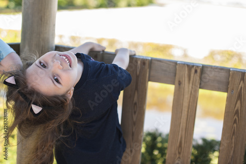 Little girl in a summer park playing. Happy child. Svobodnoe place for text. Copy space. photo