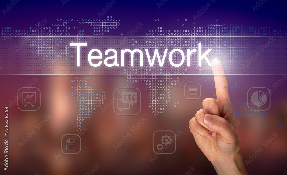 A hand selecting a Teamwork business concept on a clear screen with a colorful blurred background.