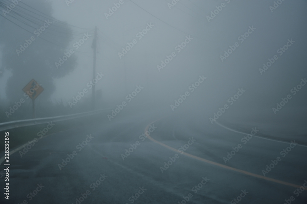 foggy rural asphalt highway perspective with white line, misty road, Road with traffic and heavy fog, bad weather driving