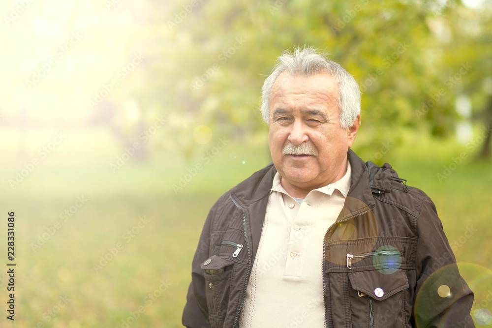 Portrait of an elderly man in the park. Portrait of an elderly man in the park.