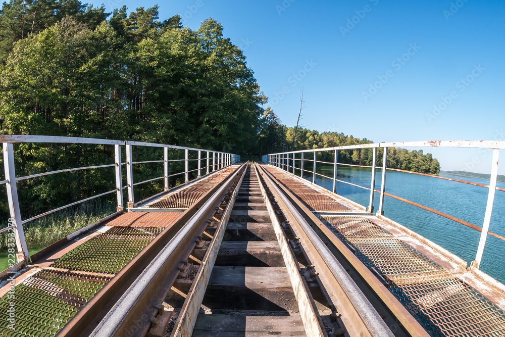 iron steel frame construction of narrow gauge railway bridge across the river. Wide angle view
