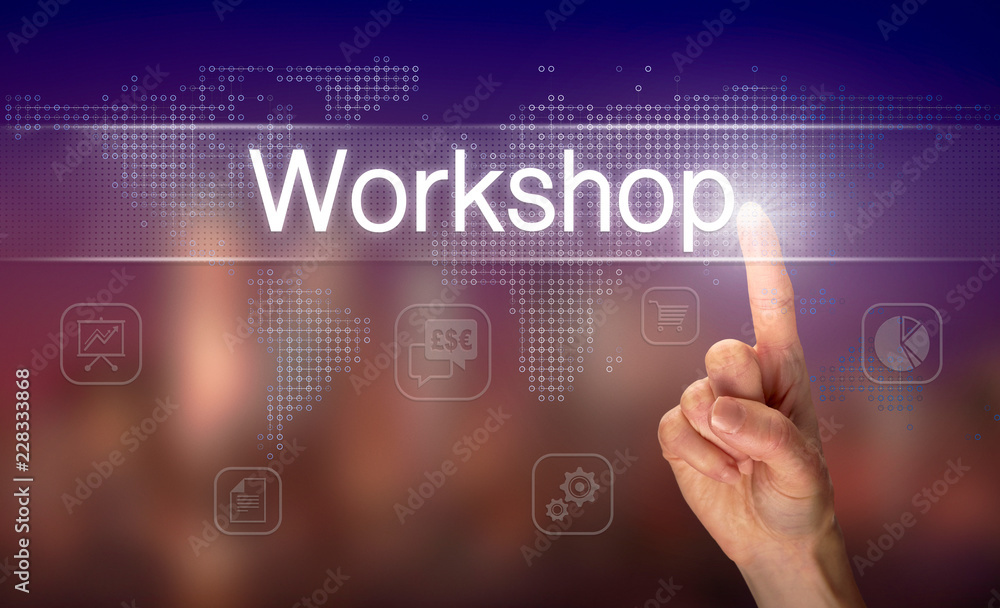 A hand selecting a Workshop business concept on a clear screen with a colorful blurred background.
