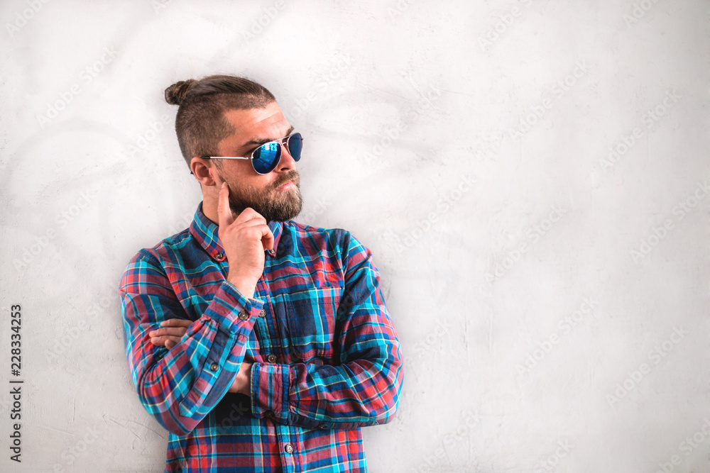 Handsome stylish man is standing near wall. Handsome stylish man is standing near wall.