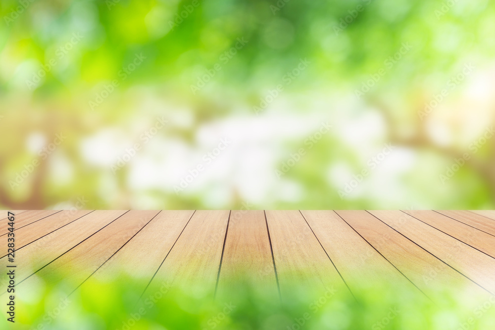 Wooden board or table and abstract blurred background. Free space can be used for photo montage or product display design and advertising Wooden board or table and abstract blurred background. Free space can be used for photo montage or product display design and advertising