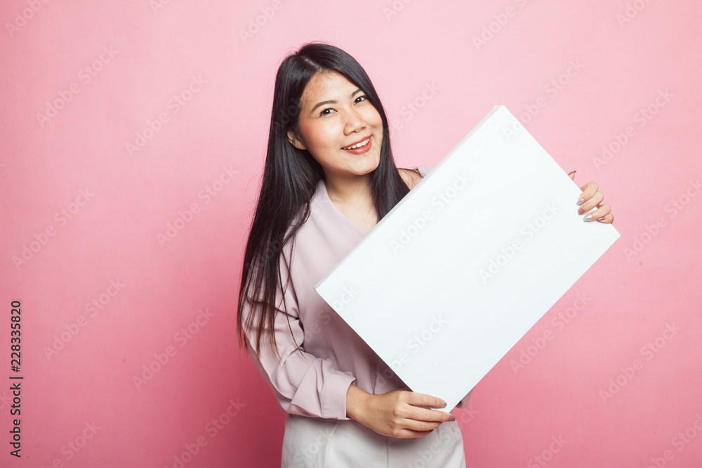 Young Asian woman with white blank sign. Young Asian woman with white blank sign.