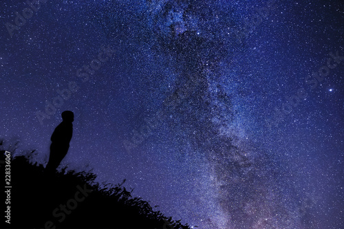 Silhouette of a lonely man watching the stars and the Cygnus Rift in Tuscany