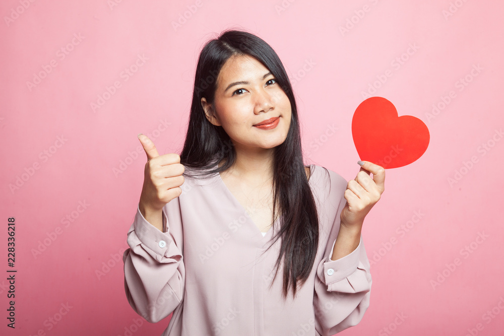 Asian woman thumbs up with red heart. Asian woman thumbs up with red heart.