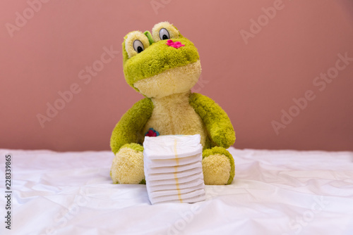 Green frog toy and diapers