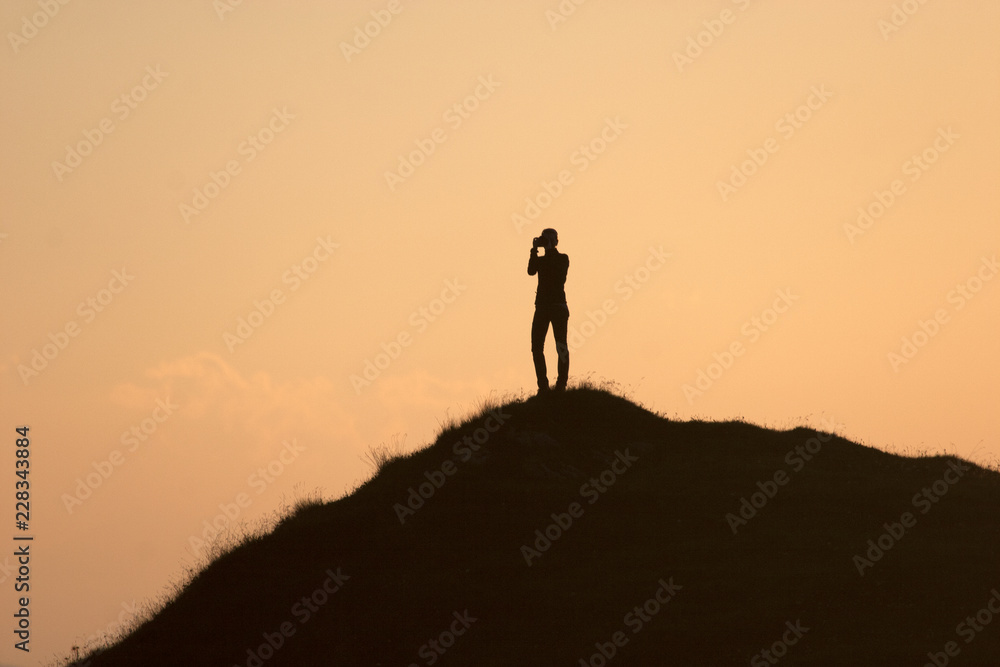 silhouette of woman on top of the mountain