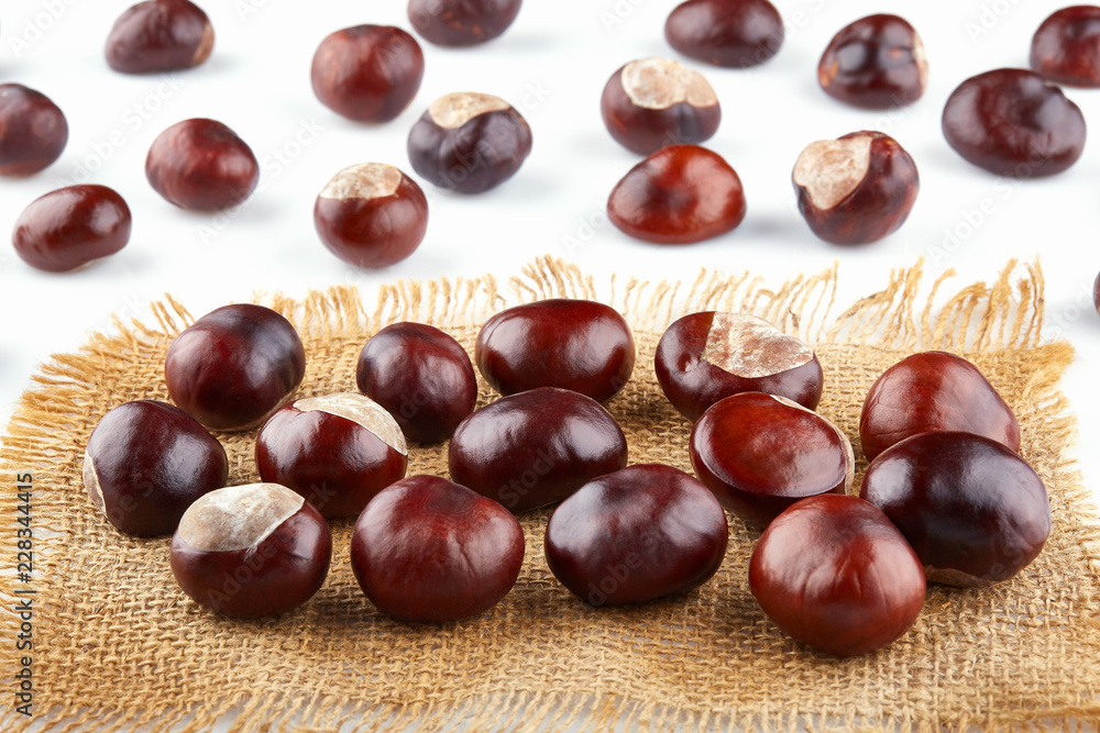 Many peeled chestnuts lie on hessian. Horse-chestnuts Many peeled chestnuts lie on hessian. Horse-chestnuts
