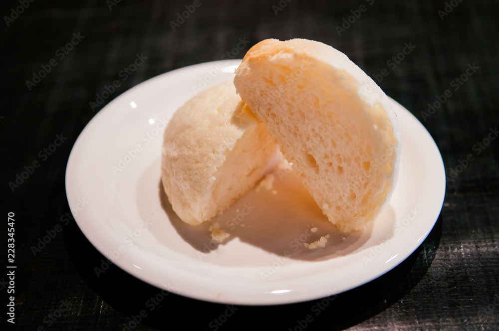 Japanese famous Melon bun cut into half on white plate of Hida Furukawa town, Gifu. Japan Japanese famous Melon bun cut into half on white plate of Hida Furukawa town, Gifu. Japan