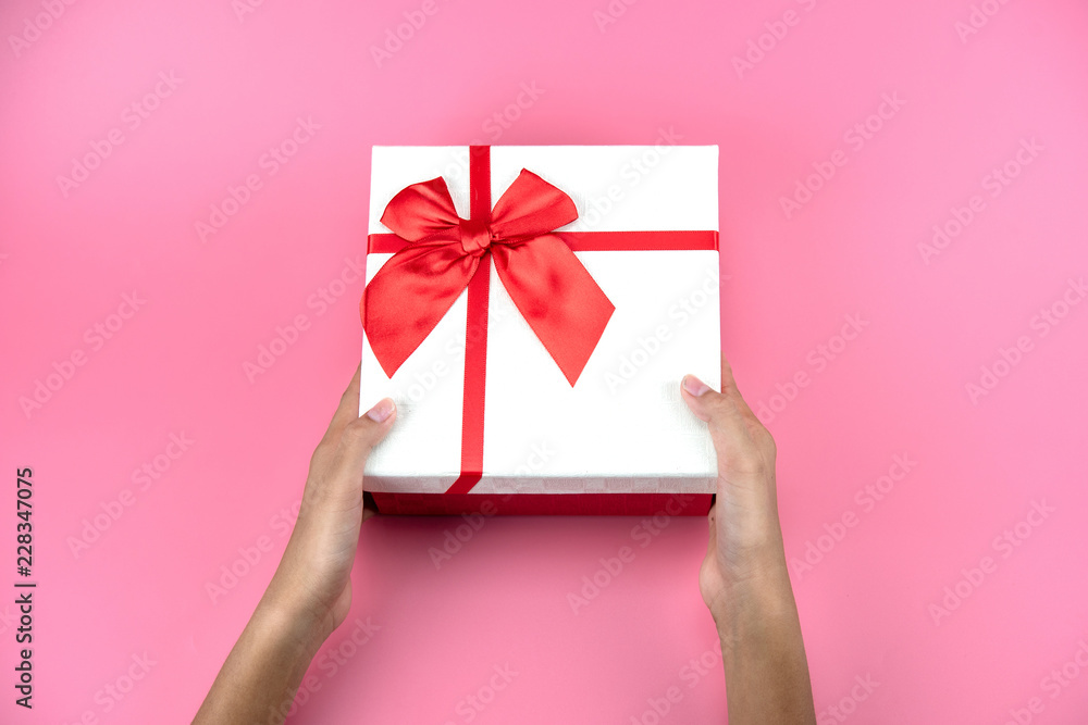 hands hold a empty red and white gift box hands hold a empty red and white gift box