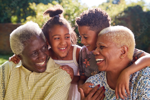 Senior black couple and grandchildren outdoors, close up photo