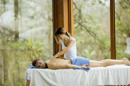 Young man having massage in...