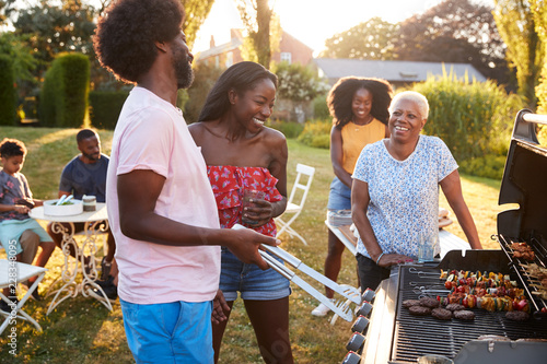 Adults talking at a multi generation family barbecue photo