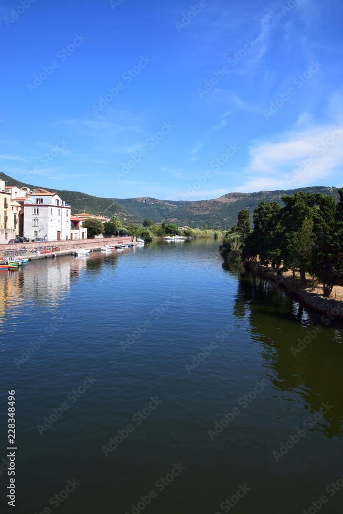 view over the river temo in sardinia, panoramic view on the boats on the river temo in Bosa in Sardinia including typical colorful Italian houses these are reflected in the river