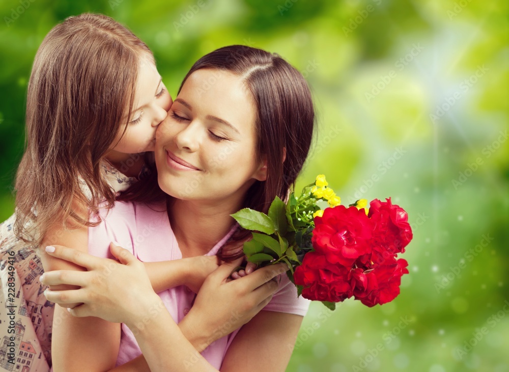 Fototapeta premium Young woman with little girl and beautiful