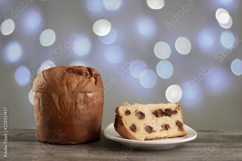 Christmas chocolate cake panettone with a slice in a light background or panetone chocotone photo