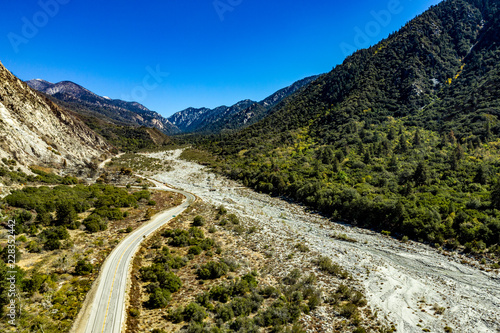 Aerial view of Forest Falls and Oak Creek in the San bernardino Mountains and National Forest with blue sky, green and yellow trees and plants