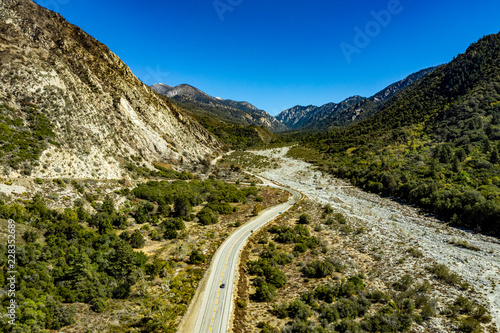 Aerial view of Forest Falls and Oak Creek in the San bernardino Mountains and National Forest with blue sky  green and yellow trees and plants