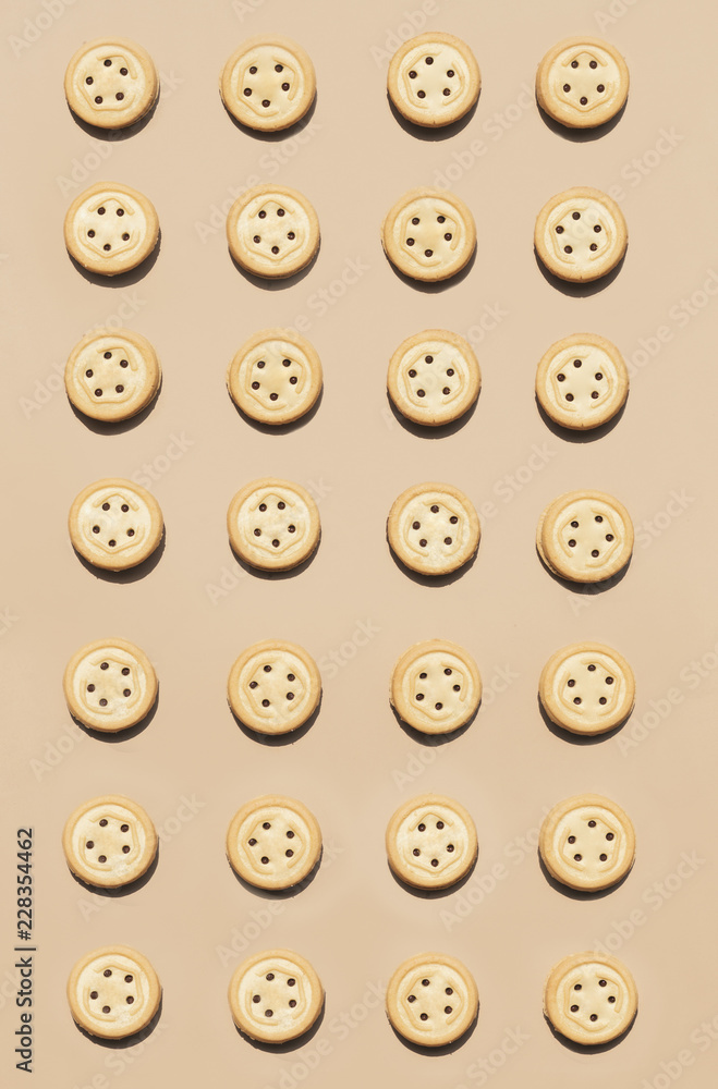 Round walnut cookies on a caramel coloured background. Round walnut cookies on a caramel coloured background.