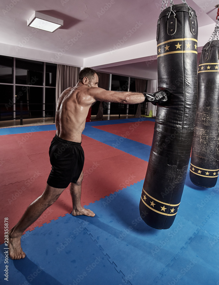 Muay thai fighter working with heavy bag