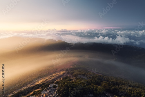 Aerial shot of mountains with clouds in the background photo