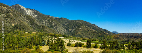 Aerial, drone view of Oak Glen located between the San Bernardino Mountains and Little San Bernardino Mountains with several apple orchards before the Fall color change