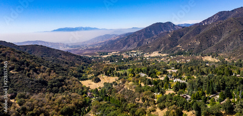 Aerial, drone view of Oak Glen located between the San Bernardino Mountains and Little San Bernardino Mountains with several apple orchards before the Fall color change © joel