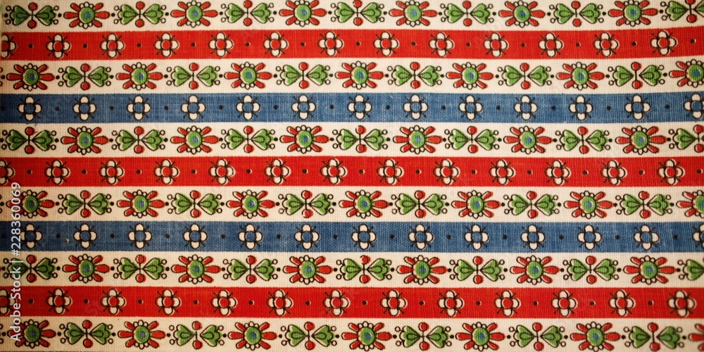 Fragment of colorful retro tapestry text. Fabric striped, flowered texture. Fragment of colorful retro tapestry text. Fabric striped, flowered texture.