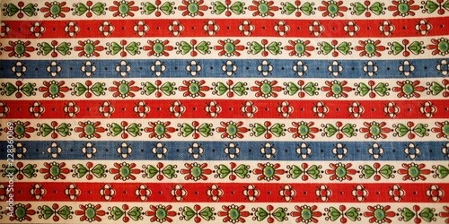 Fragment of colorful retro tapestry text. Fabric striped, flowered texture.