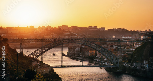 Aerial view of Porto with Douro river and famous view of Dom Luis I Bridge in skyline at sunset, Portugal