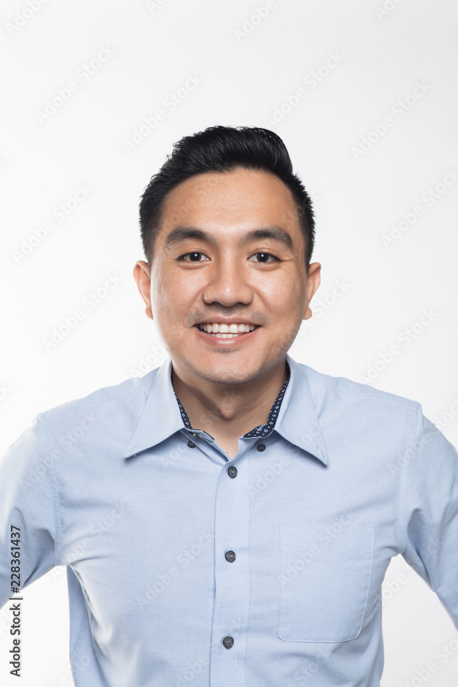 Asian man in work attire looking very happy Asian man in work attire looking very happy