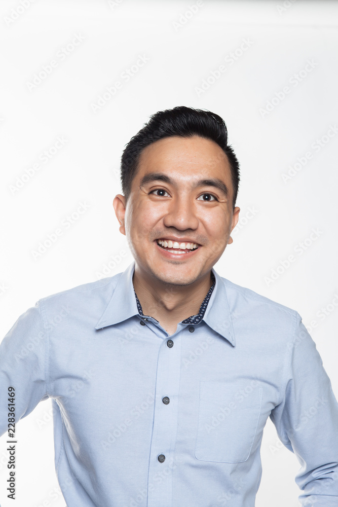 Asian man in work attire looking very happy Asian man in work attire looking very happy