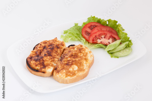 Grilled sandwiches with egg and cheese for breakfast. Decorated with vegetables in white plate